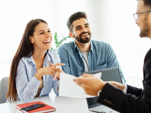 Couple signing documents advisor